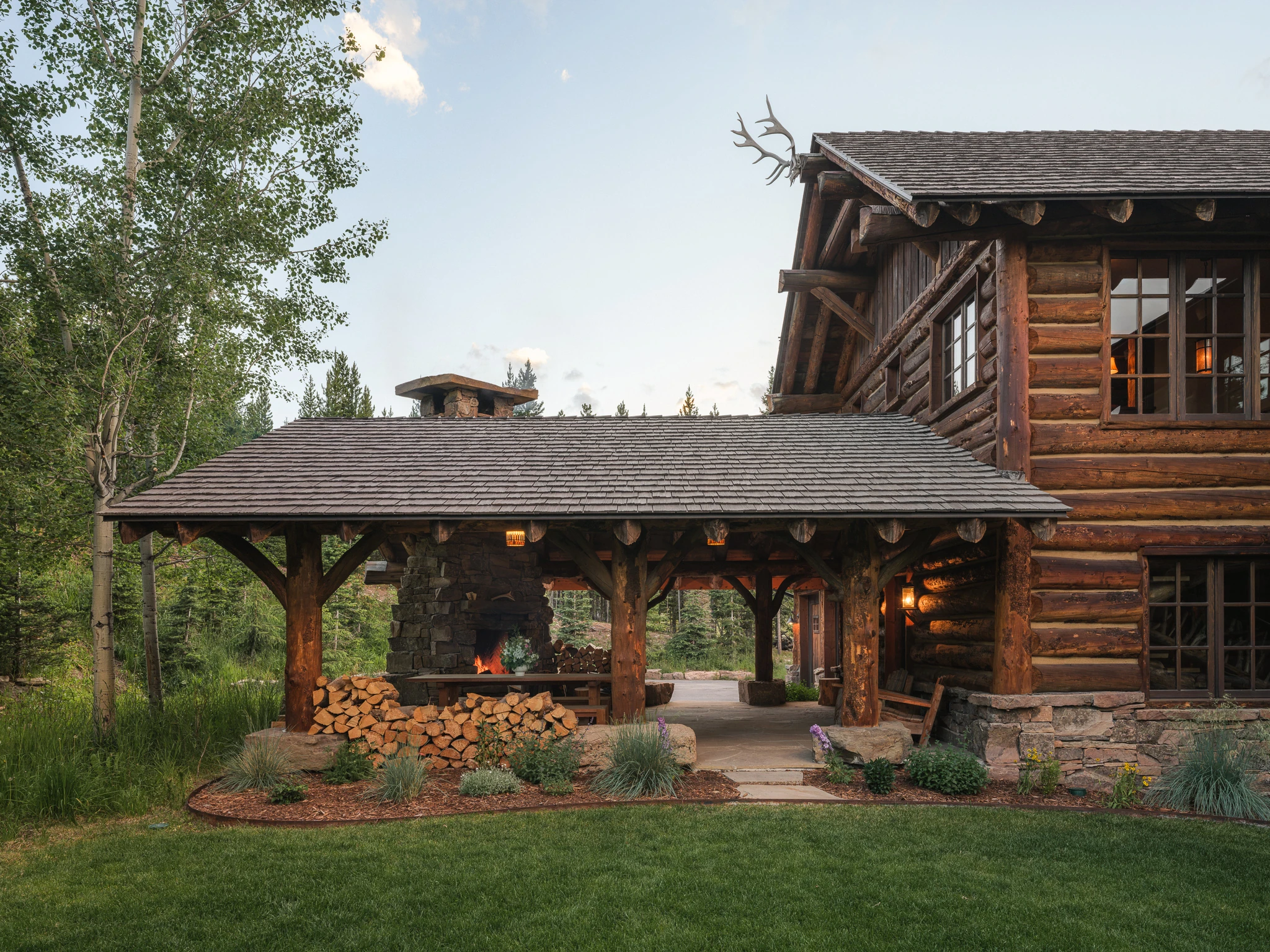 Covered breezeway and stone fireplace exterior — architectural photography Big Sky Montana, Lohss Construction